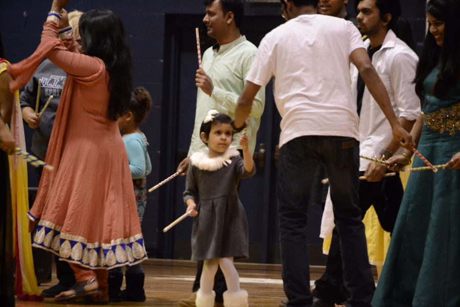 A young child participates in the Dandiya dance at the celebration. 