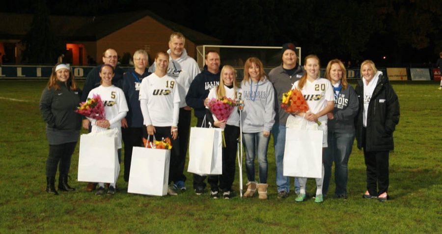 Alena Miller, Madisyn Coudriet, Sam Boettjer, and Alena Eitenmiller are honored with flowers during Senior Night.