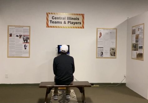 A museum goer sitting on the bench watching a program at the Springfield and Central Illinois African American History Museum | Photo credit: Richard Bailey