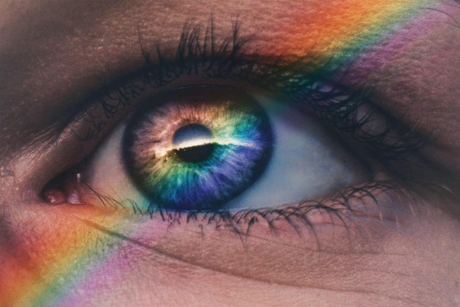 An upclose shot of an eye with a rainbow | Photo Credit:  Harry Quan on Unsplash