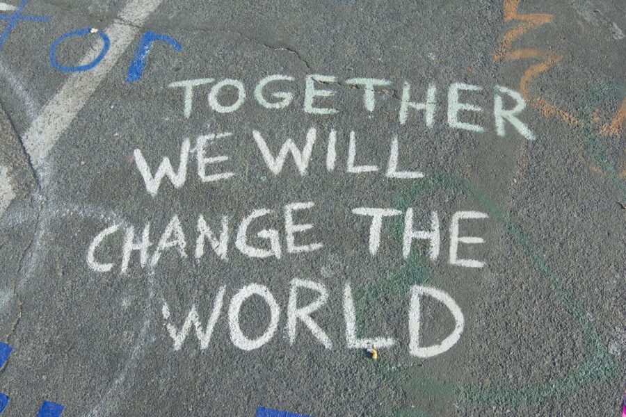 Chalk writing on the street near the George Floyd memorial in Minneapolis. Together we will change the world. | Photo Credit: Photo by Priscilla Gyamfi on Unsplash