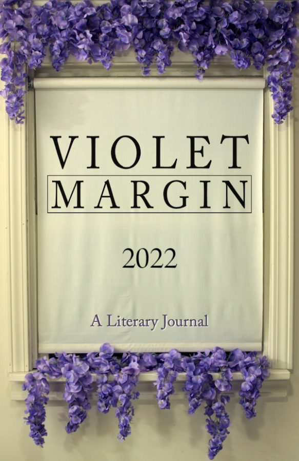 A window with the shade pulled down with violet flowers. | Photo Credit: Violet Margin