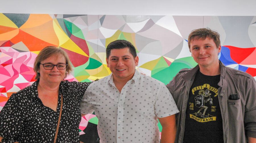 Mauricio Ramirez (middle) with gallery attendees. Photo Credit: Jae Scott