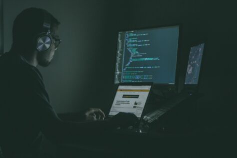 A man works on cyber threats at a workstation. | Photo Credit: Jefferson Santos on Unsplash