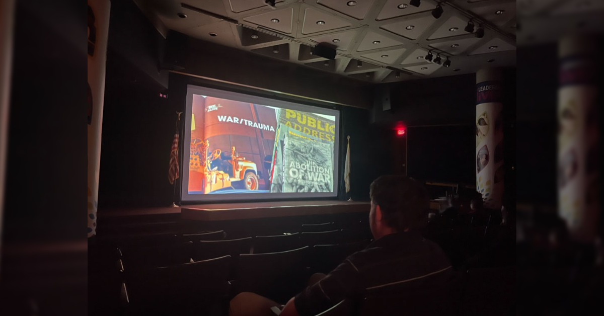 UIS Student at the Brookens Library Auditorium watching The Art of Un-War | Photo credit: Bwayisak Tanko