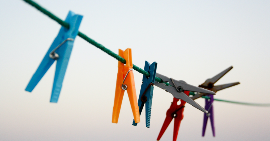 A picture containing multiple colored clothes pins on a line | Photo Credit: Unpslash