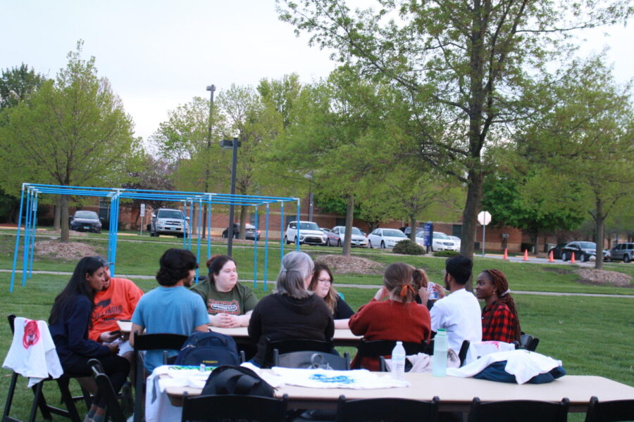 UIS Students sitting at a table at the Block Party | Photo Credit: Bwayisak Tanko