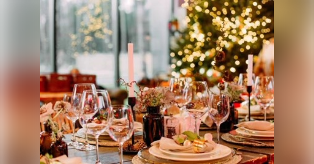 Festive large table decorated with Christmas symbols candles | Photo Credit: Yuriy Kovtun