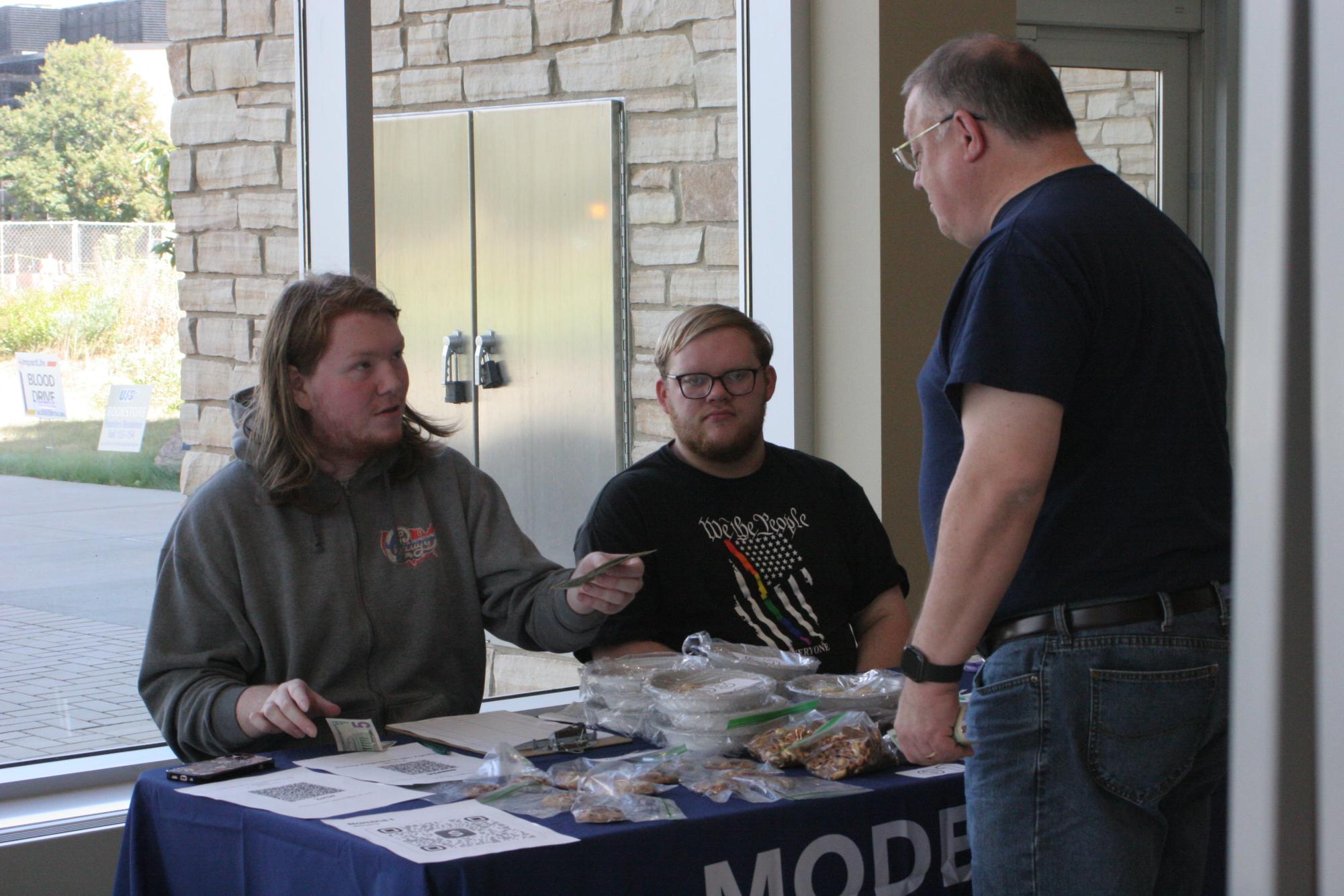Members of the UIS Model United Nations team sell baked goods at the Student Union to support travel to the National Model United Nations conference in New York City.
