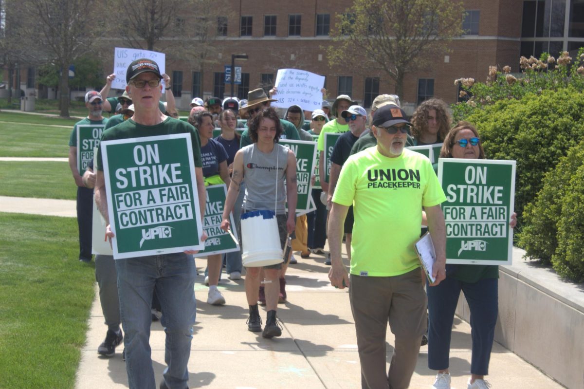 Striking faculty members march around the Colonnade on April 13 holding signs and chanting slogans.
